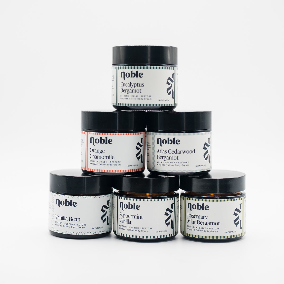 Six Noble Skin Co. 2 oz body tallow jars shown as scent inspiration; choose three available scents for the Body Tallow Trio.
