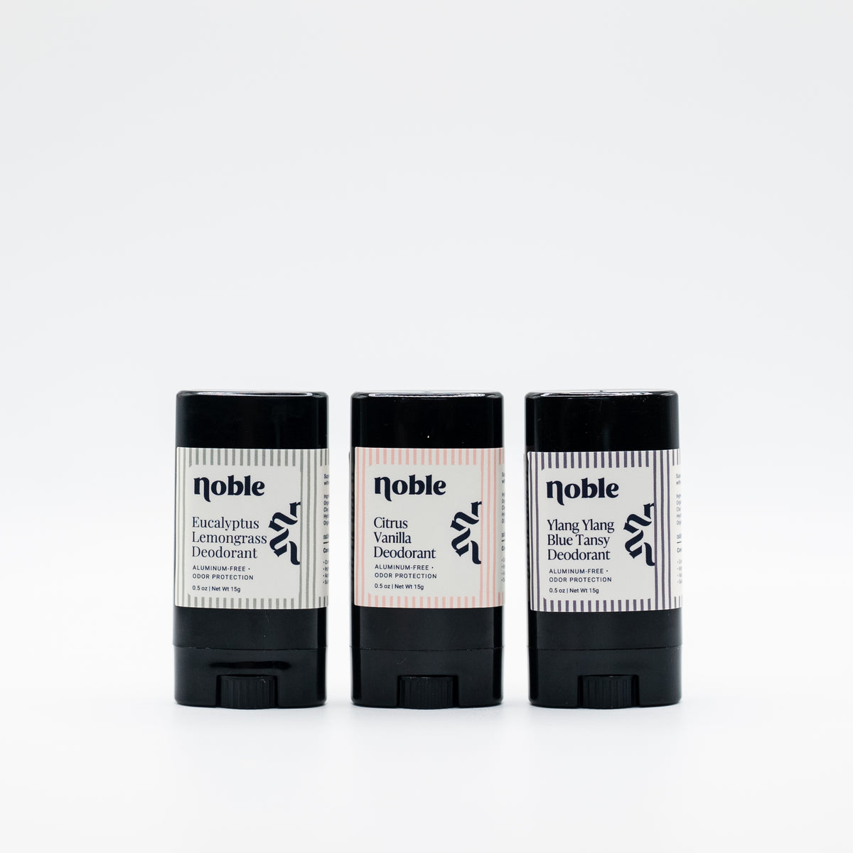 Three example Noble Skin Co. travel deodorants in alternate assorted scents