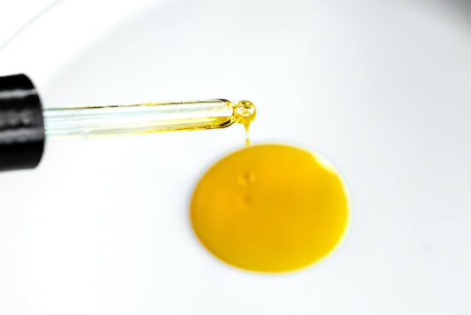 Dropper releasing Clear Skin Serum used for oil cleansing method and natural skincare