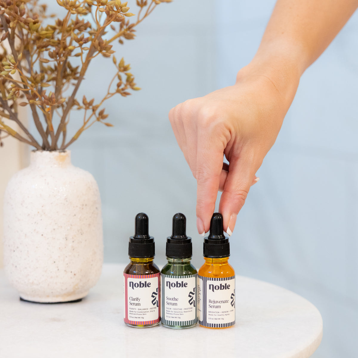 Clarify, Soothe and Rejuvenate Face Serum bottles arranged together.