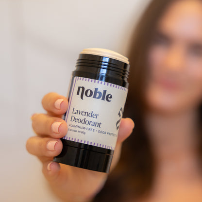 Person holding an open Lavender Deodorant stick.