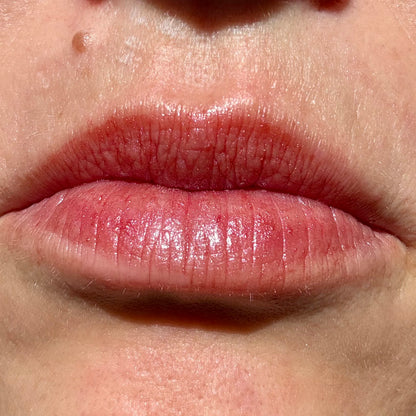 Close-up of lips wearing Noble Skin Co. Grace Maroon tinted lip balm with a sheer, moisturizing burgundy hue.