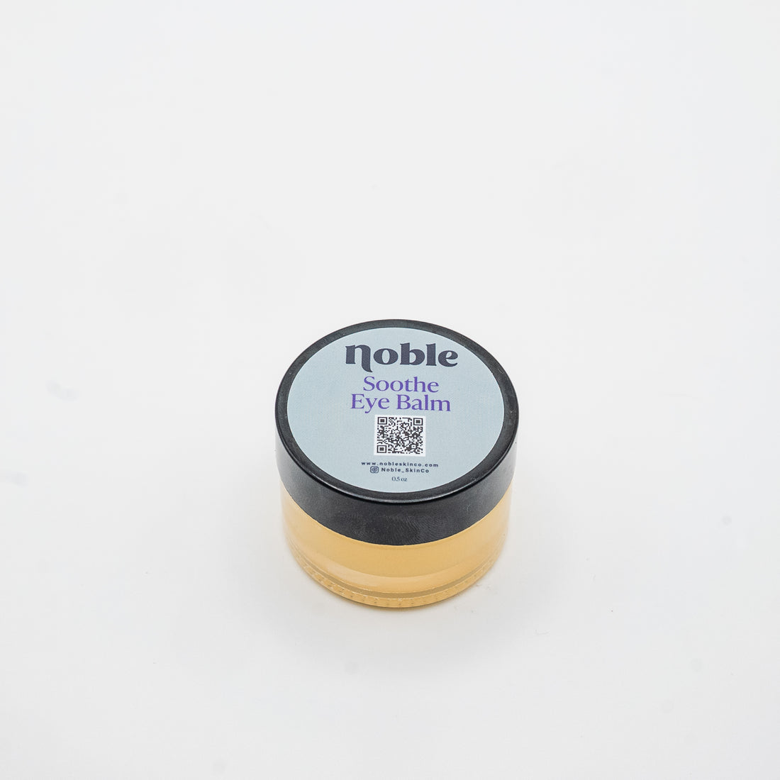 Noble Skin Co. Soothe Eye Balm 0.5 oz clear glass jar with labeled black lid