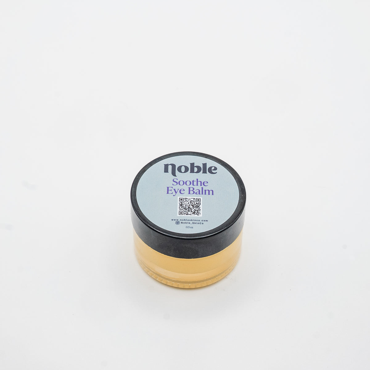 Noble Skin Co. Soothe Eye Balm 0.5 oz clear glass jar with labeled black lid