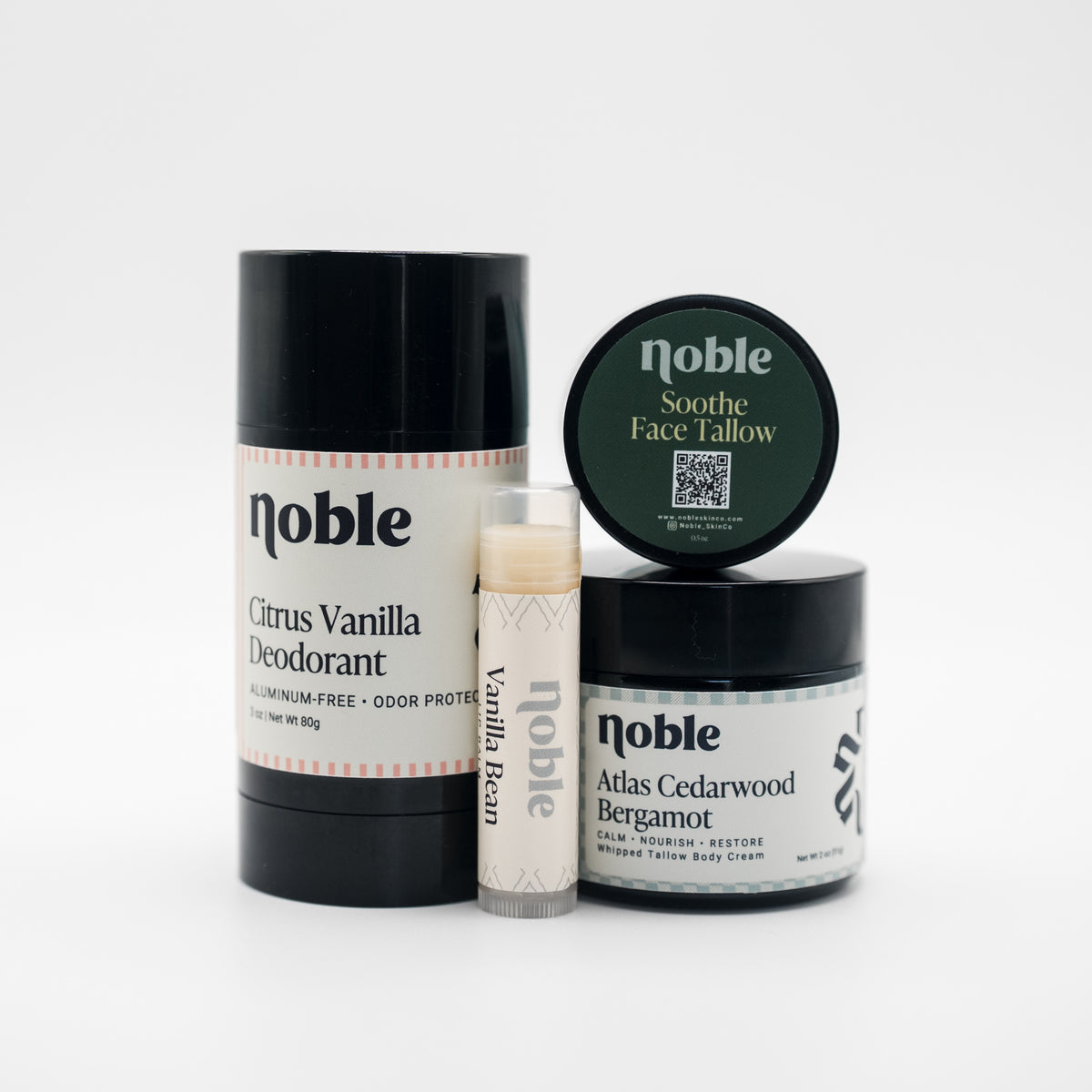Noble Starter Ritual shown with Citrus Vanilla Deodorant 3 oz, Vanilla Bean Lip Balm, Soothe Face Tallow 0.5 oz, and Atlas Cedarwood Bergamot Body Tallow 2 oz.