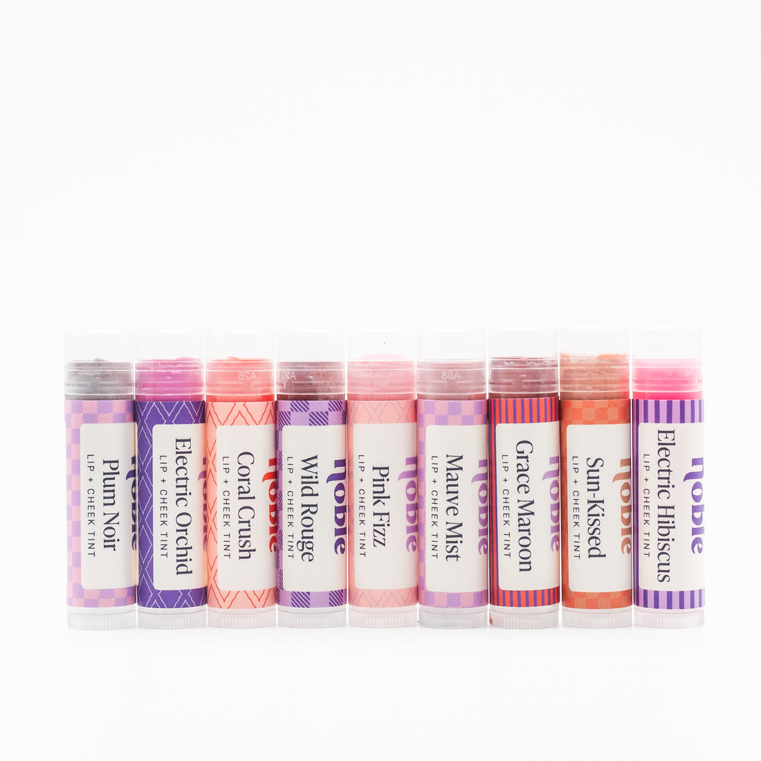 Noble Skin Co. Tinted Tallow Lip Balm + Cheek Stain group of nine sticks with shade labels facing forward