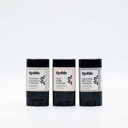Three example Noble Skin Co. travel deodorants in alternate assorted scents