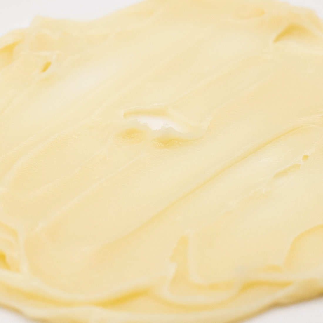 Pale golden tallow texture close-up.