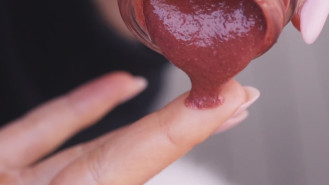 Reddish Rejuvenate Face Mask scooped from an open jar.