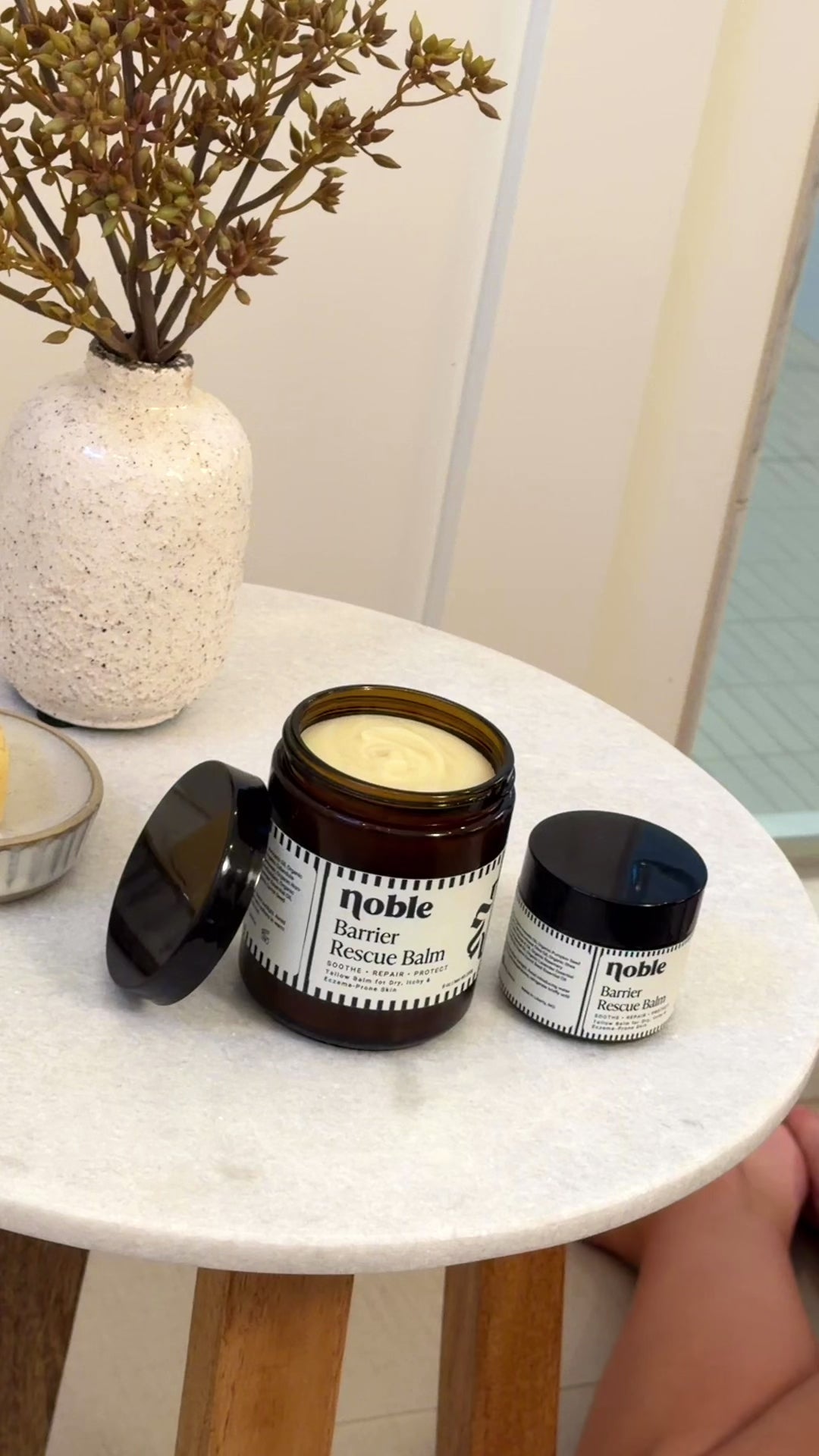 Video of Barrier Rescue Balm jars and cream application to a forearm.